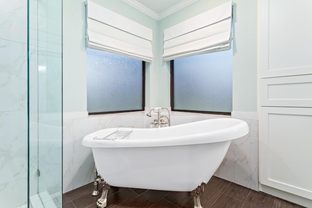 bathroom with tile walls, a bathtub, and ornamental molding