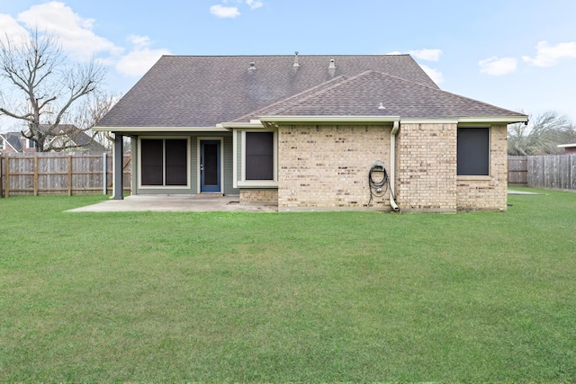 back of house featuring a yard and a patio area