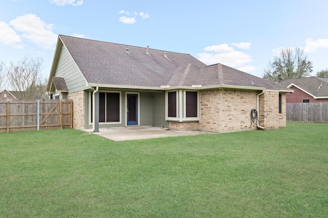 back of property with a patio area and a lawn