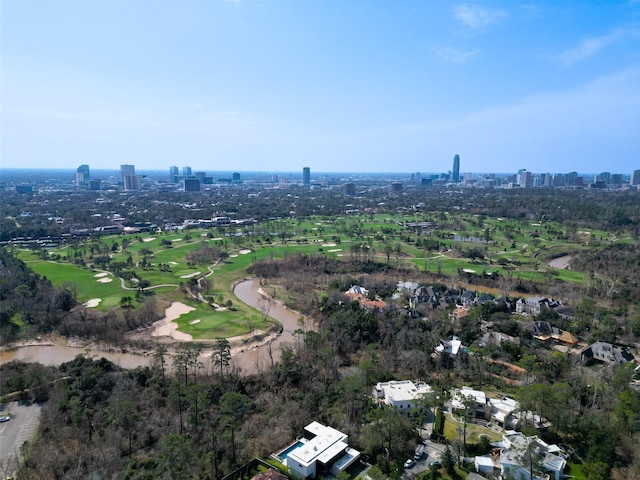 birds eye view of property with a city view and golf course view