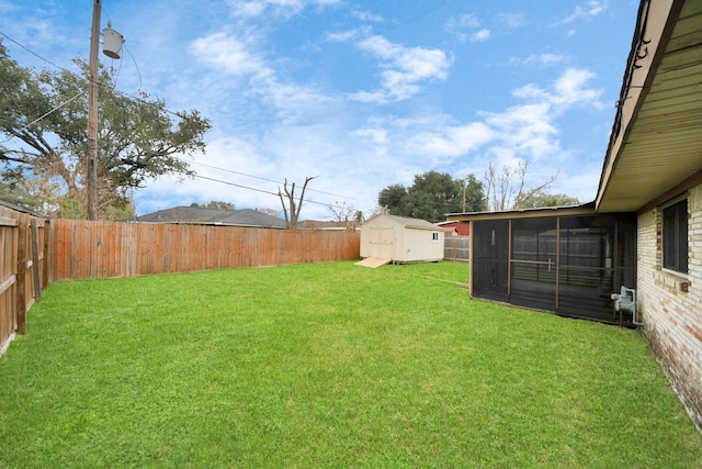 view of yard featuring a storage shed and a sunroom