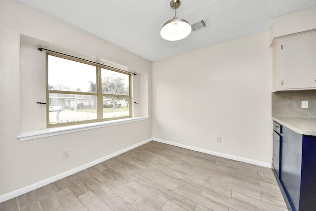 unfurnished dining area with light hardwood / wood-style flooring