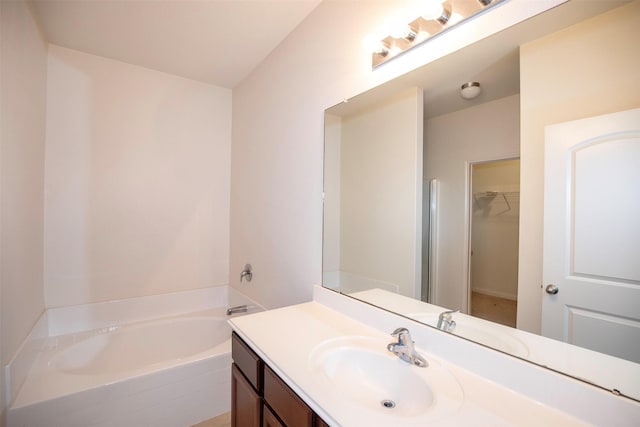 bathroom with vanity and a tub to relax in