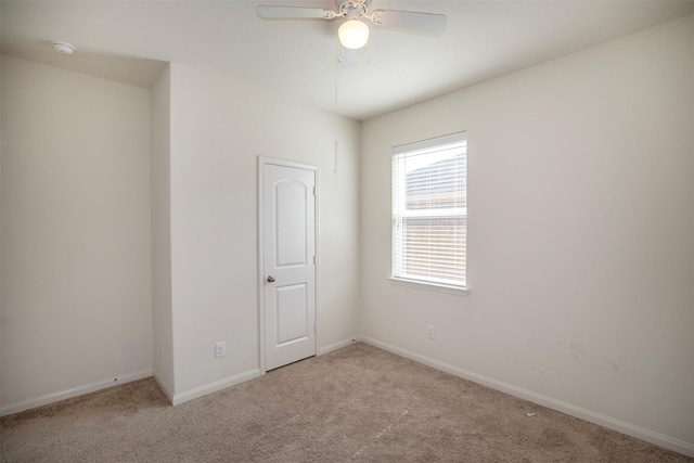 empty room featuring light carpet and ceiling fan