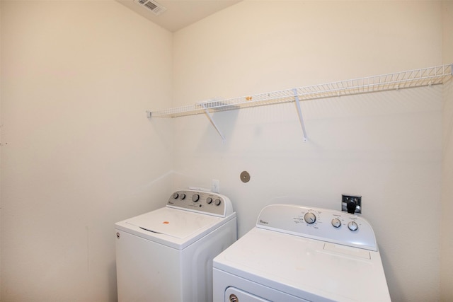 clothes washing area with separate washer and dryer