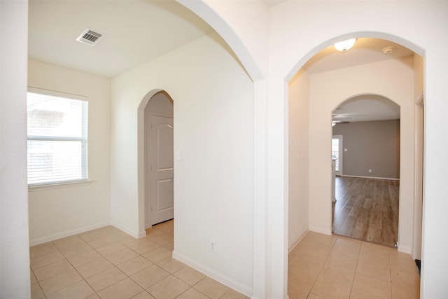 hall featuring light tile patterned flooring