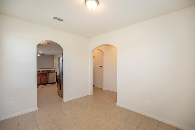 spare room with sink and light tile patterned floors