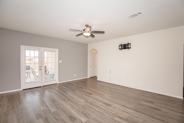 spare room with hardwood / wood-style flooring and ceiling fan