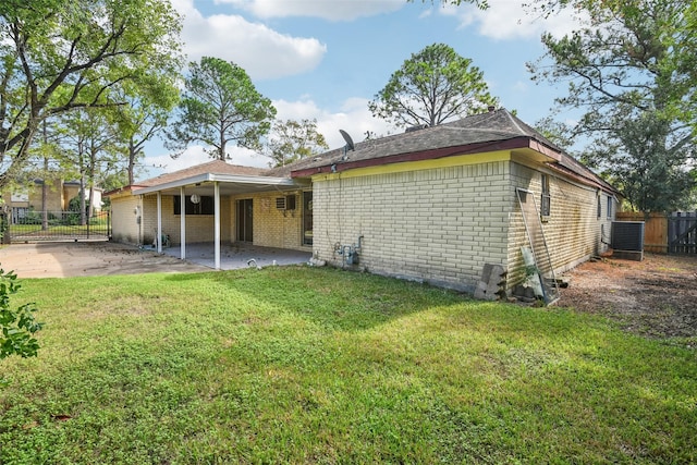 rear view of property with central air condition unit, a patio area, and a lawn