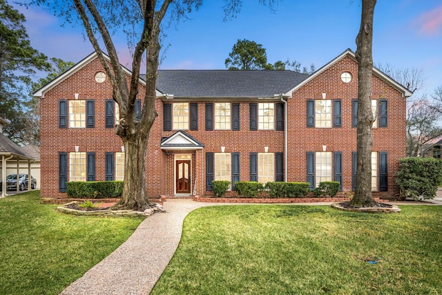 view of front of property with brick siding and a front yard