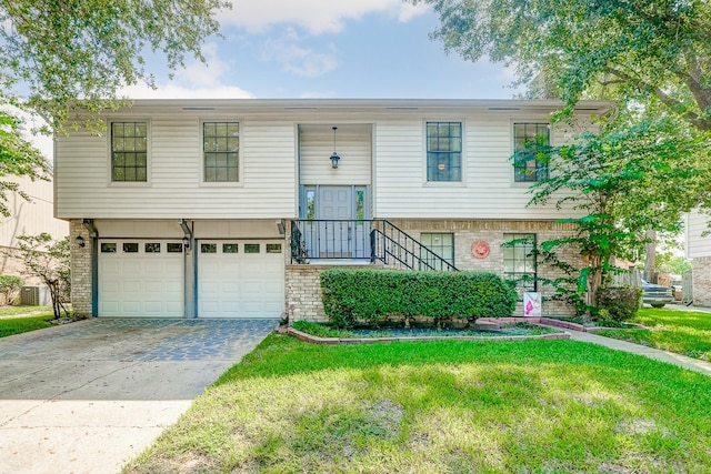 split foyer home featuring a garage and a front yard