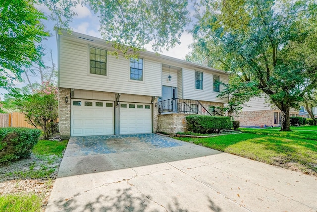 bi-level home with a garage and a front yard