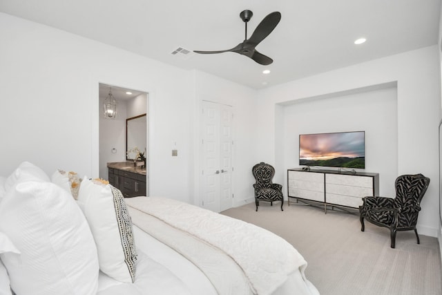 bedroom with light carpet, connected bathroom, ceiling fan, and a closet