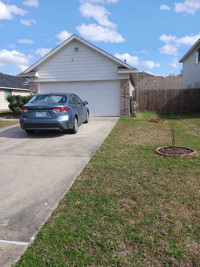 exterior space featuring a garage and a yard