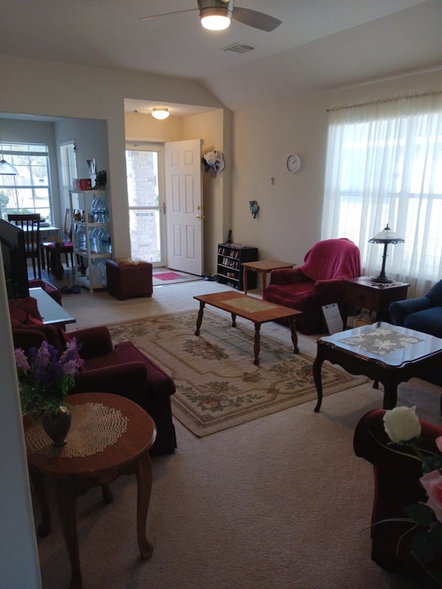 living room featuring vaulted ceiling, ceiling fan, and carpet floors