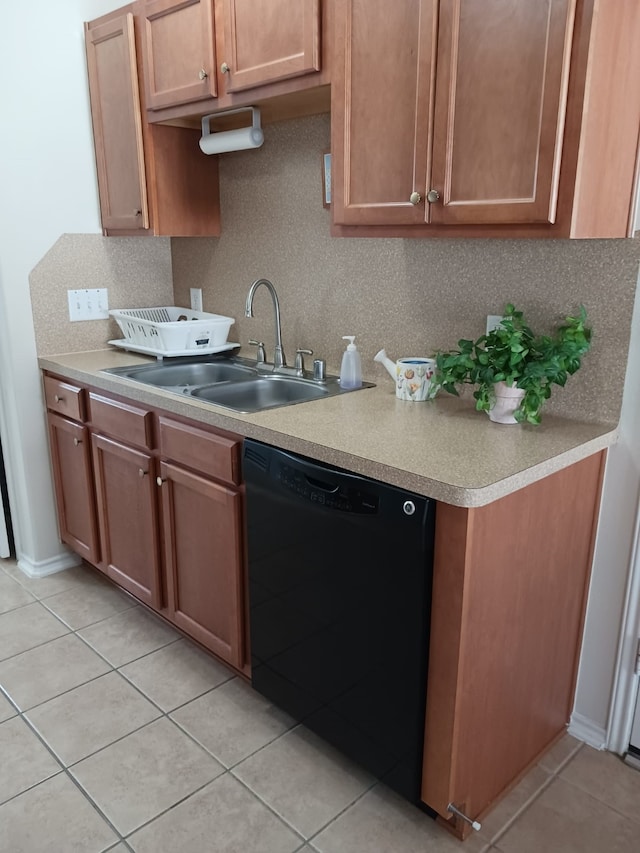 kitchen with tasteful backsplash, light tile patterned flooring, dishwasher, and sink