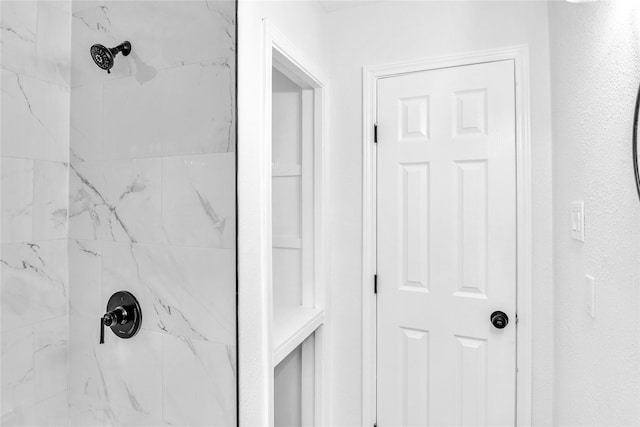 bathroom with a tile shower