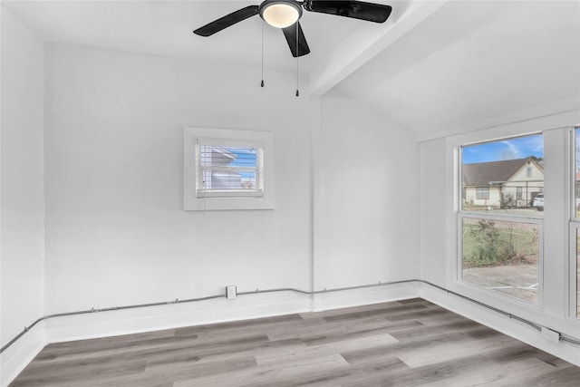 spare room featuring vaulted ceiling, ceiling fan, and light hardwood / wood-style floors