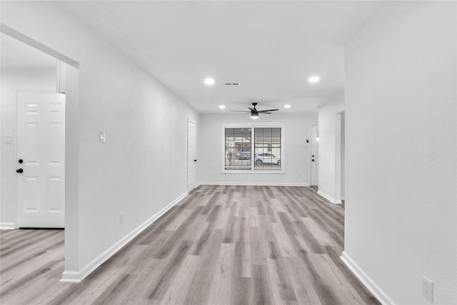 unfurnished living room featuring ceiling fan and light hardwood / wood-style floors