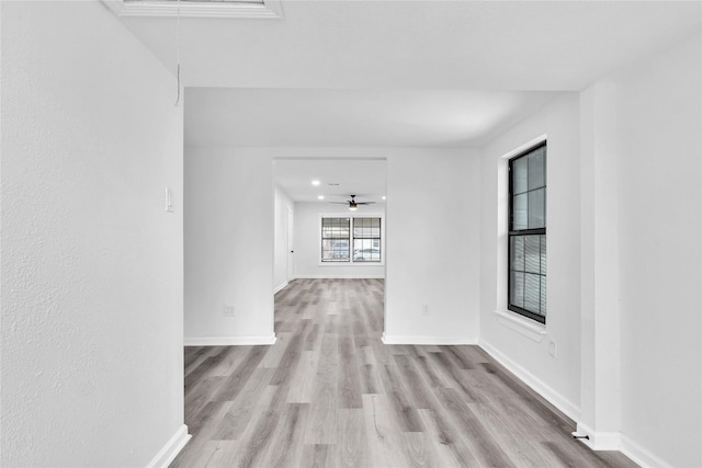 unfurnished room with ceiling fan and light hardwood / wood-style flooring