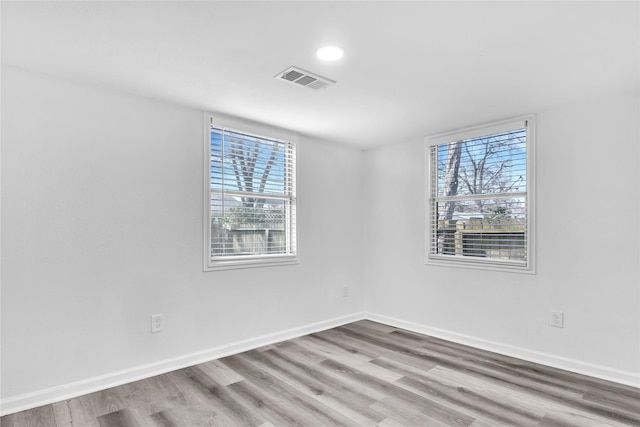 unfurnished room with light hardwood / wood-style floors