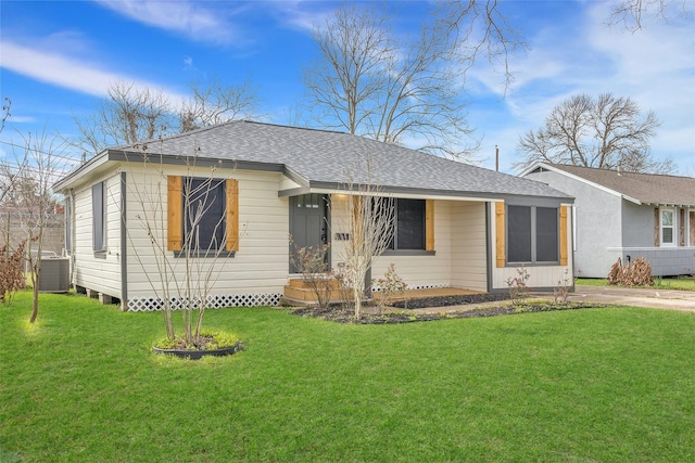 ranch-style house featuring cooling unit and a front yard