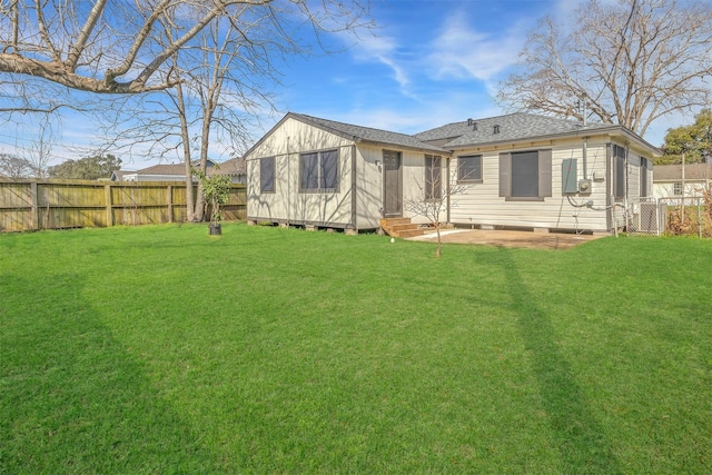 rear view of property featuring a lawn and a patio area