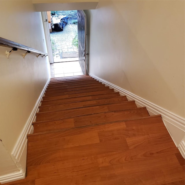 staircase featuring wood-type flooring