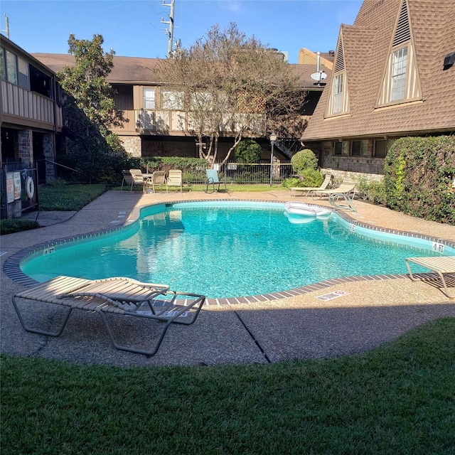 view of pool with a yard and a patio area