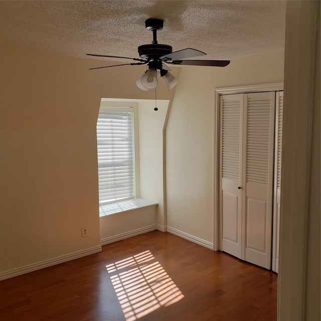 unfurnished bedroom featuring hardwood / wood-style flooring, a closet, and a textured ceiling