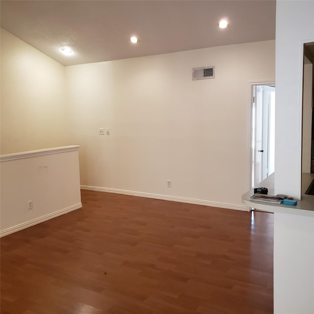 empty room featuring dark wood-type flooring