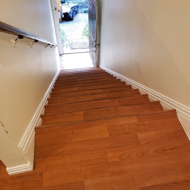 staircase featuring wood-type flooring