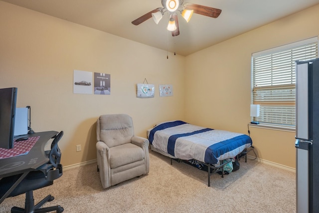 bedroom featuring light carpet and ceiling fan