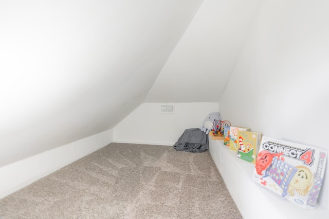 bonus room with lofted ceiling and light colored carpet