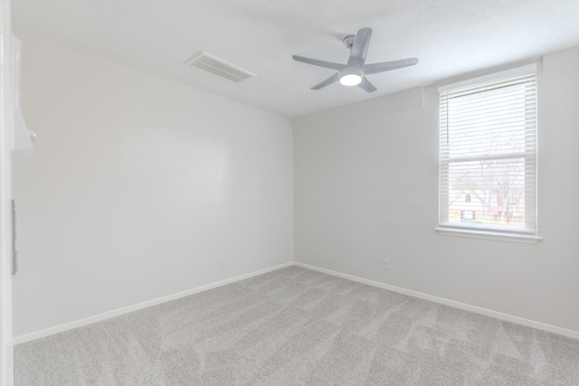 carpeted spare room with a textured ceiling and ceiling fan