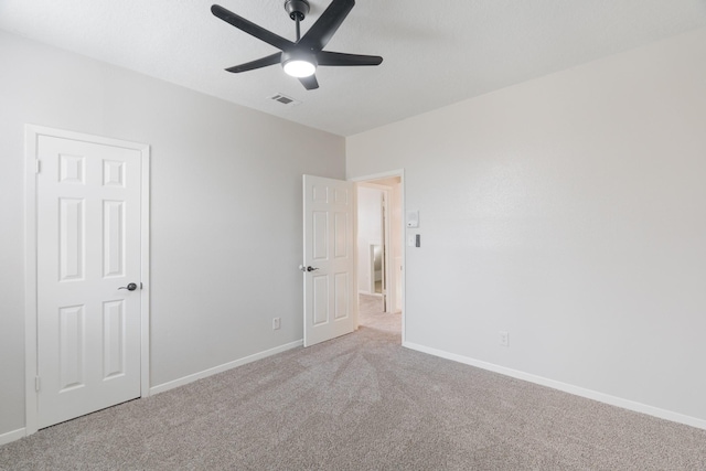 empty room with light carpet and ceiling fan