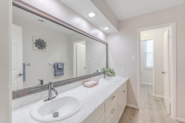 bathroom with vanity and wood-type flooring