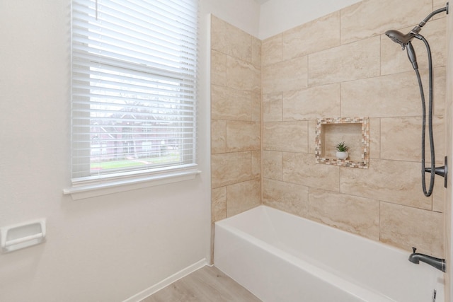 bathroom featuring tiled shower / bath combo and hardwood / wood-style flooring