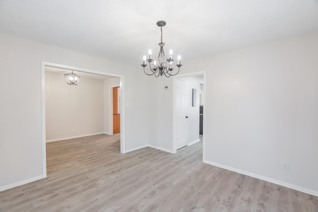 unfurnished dining area with light hardwood / wood-style flooring and a chandelier