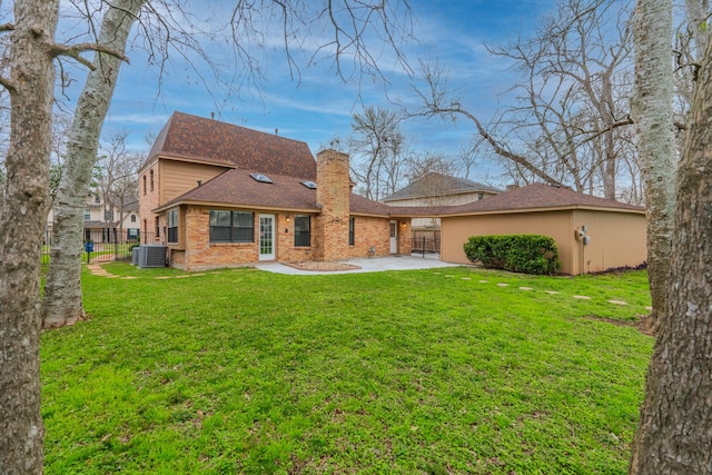 rear view of house featuring central AC and a yard