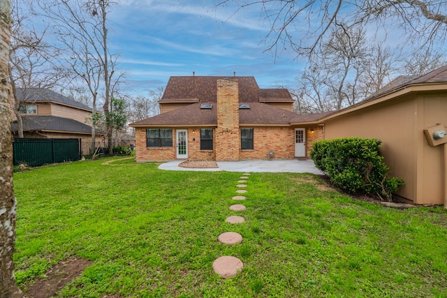 rear view of house with a yard and a patio