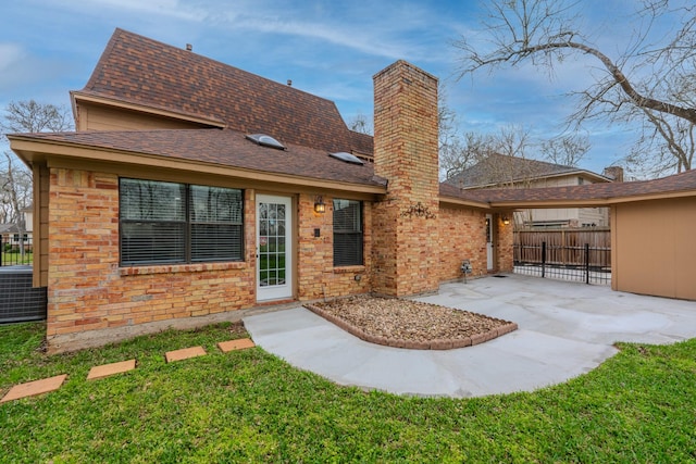 rear view of property featuring cooling unit, a patio area, and a lawn