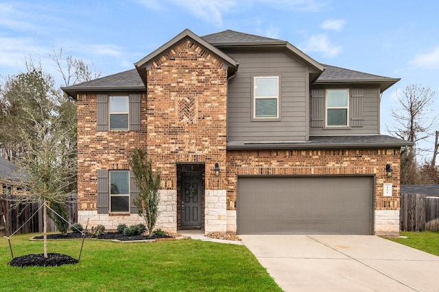 view of property with a garage and a front lawn