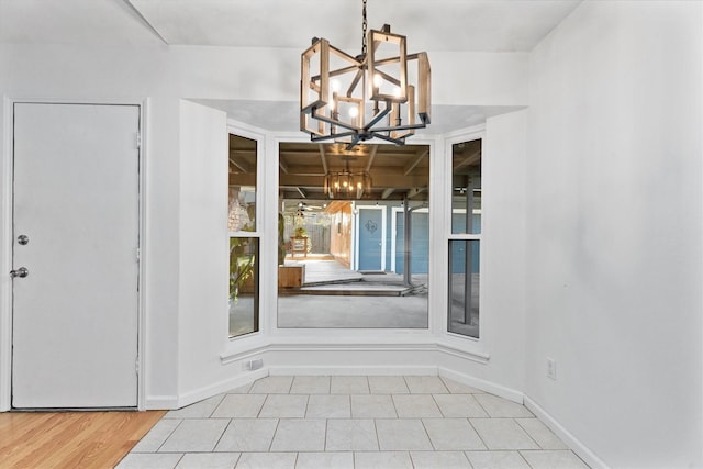 unfurnished dining area featuring a chandelier