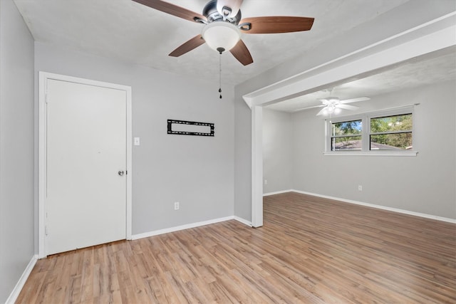 unfurnished room with ceiling fan and light wood-type flooring