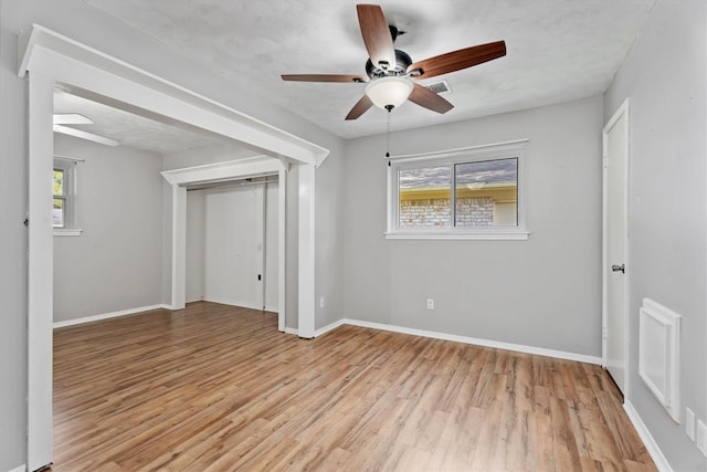 unfurnished room featuring ceiling fan, plenty of natural light, and light hardwood / wood-style floors