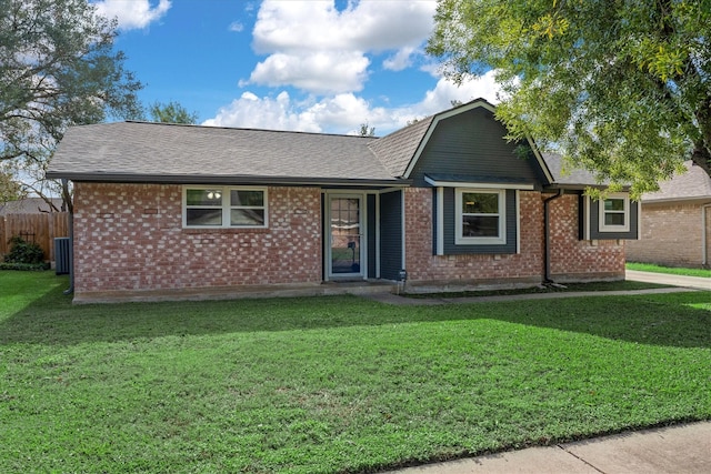 ranch-style home featuring a front yard and central AC unit