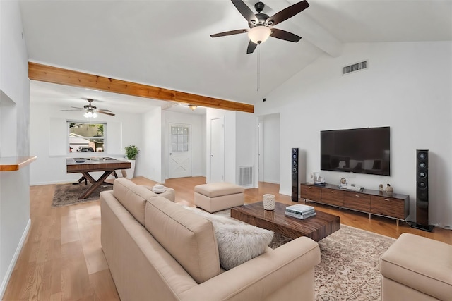 living room with ceiling fan, vaulted ceiling with beams, and light hardwood / wood-style floors