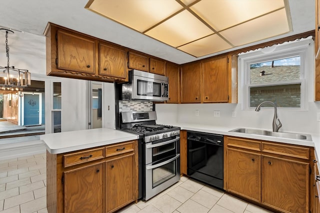 kitchen featuring sink, stainless steel appliances, tasteful backsplash, light tile patterned flooring, and decorative light fixtures