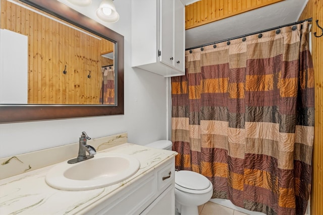 bathroom with tile patterned flooring, vanity, and toilet